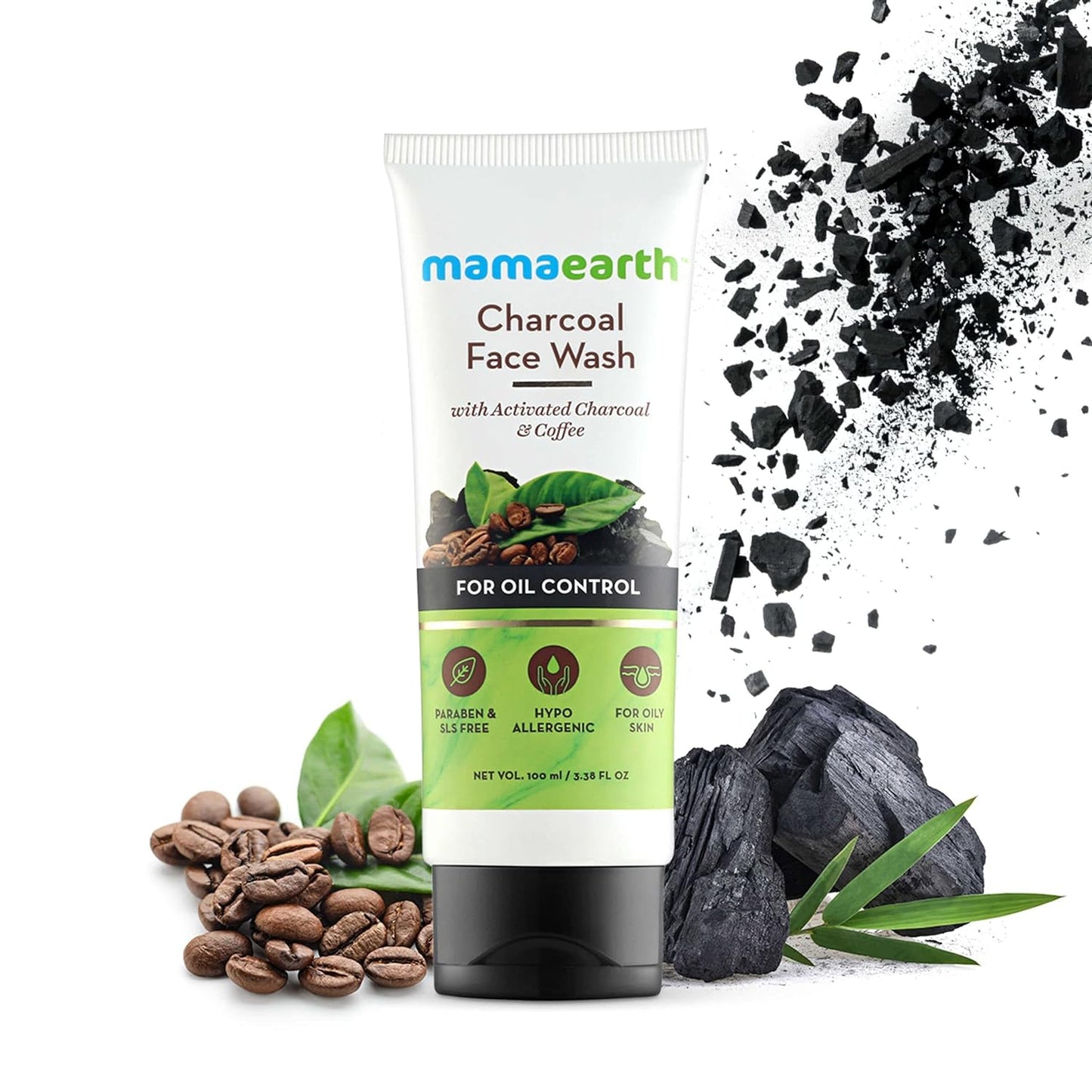 A 100ml tube of Sparkling Fusion Mamaearth Charcoal Face Wash with Activated Charcoal & Coffee for Oil Control. The image showcases coffee beans, green leaves, and chunks of charcoal to emphasize the natural ingredients. The tube highlights that it is paraben and SLS-free, hypoallergenic, and includes soothing clay for an extra gentle touch.